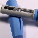 Detailed view of a semaglutide injection pen, commonly used for diabetes treatment, on a plain background.